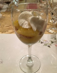 A single-serving lemon pudding dessert in a wine glass.