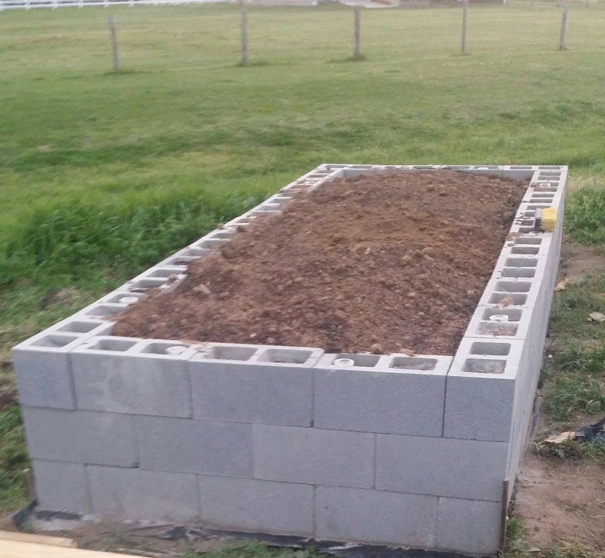 Cinder block framed raised bed filled with soil.