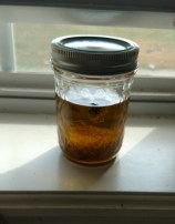Calendula Flowers in Oil, located in a windowsill