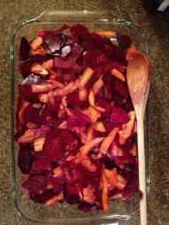 Sliced Beet Roots and Carrots in glass dish with salt and Dill seed added.